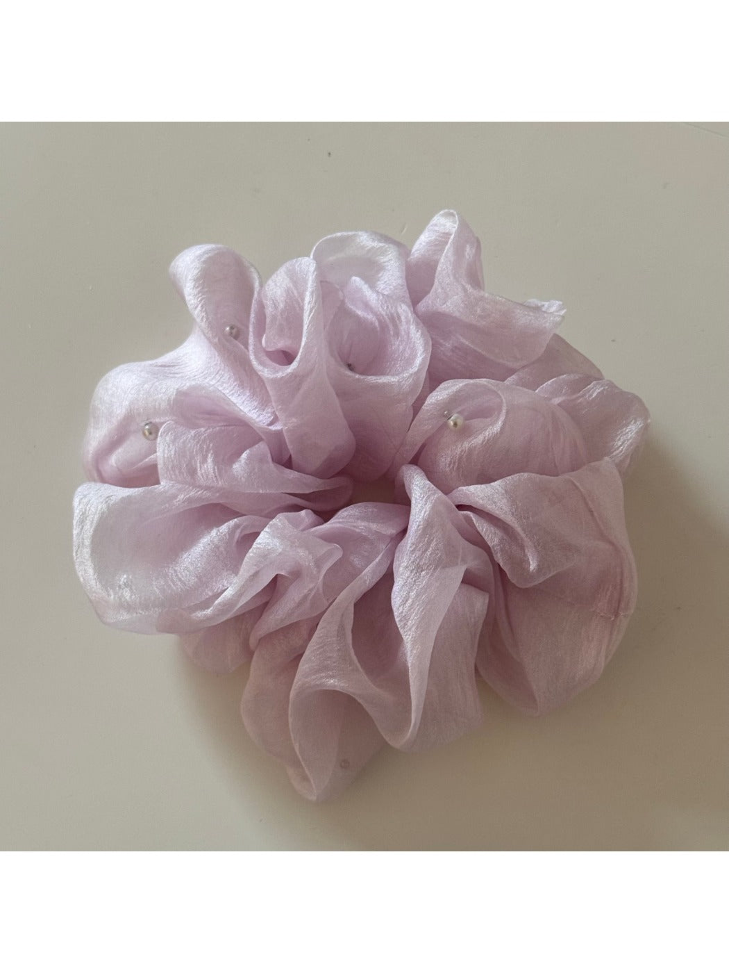 Gifty scrunchie in a loose bun hairstyle with natural lighting