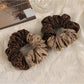 Gifty modern retro aesthetic scrunchie in pastel pink fabric on white background