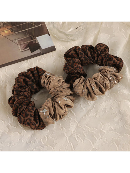 Gifty modern retro aesthetic scrunchie in pastel pink fabric on white background