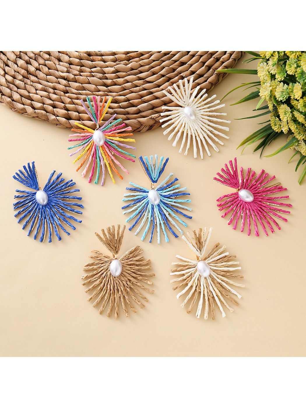 Close-up of Earedge elegant raffia drop earrings on white background
