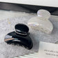 Beau half round hair claw clip showing curved teeth and spring mechanism
