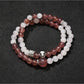 Lovra bracelet coiled on a wooden surface showcasing natural bead colors