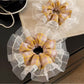 Vintage yellow plaid scrunchie displayed on a white background