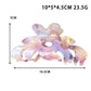 Beau flower shaped claw clip held in hand showing size and shape