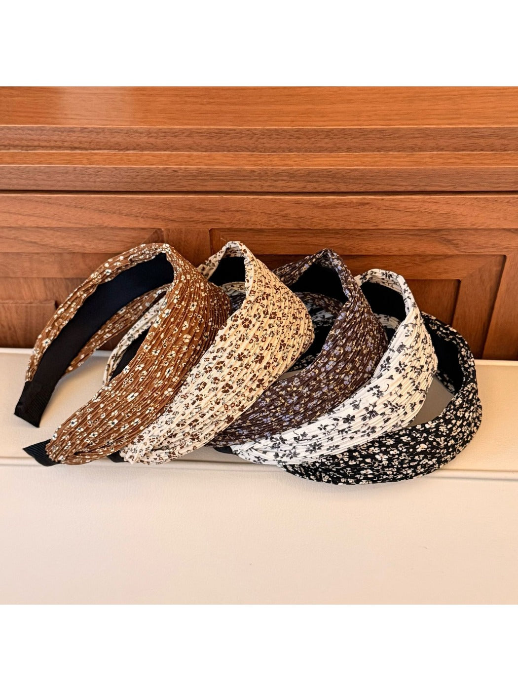 Wide vintage print headband in earthy tones styled on a mannequin head