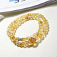 Lovra yellow crystal bracelet wrapped multiple times around a wrist