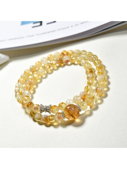 Lovra yellow crystal bracelet wrapped multiple times around a wrist