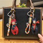 Vintage bear pendant keychain hanging from a set of keys on a wooden table