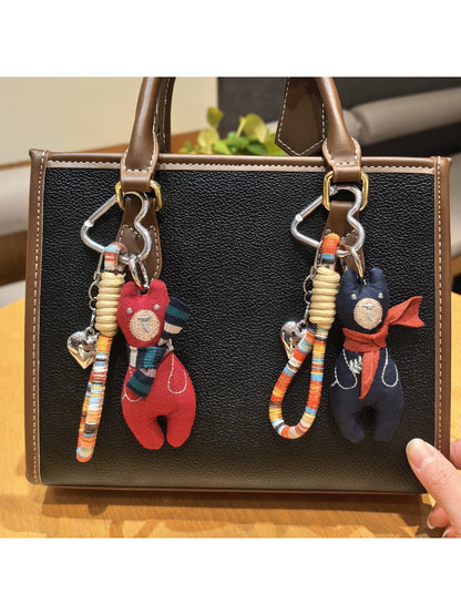 Vintage bear pendant keychain hanging from a set of keys on a wooden table