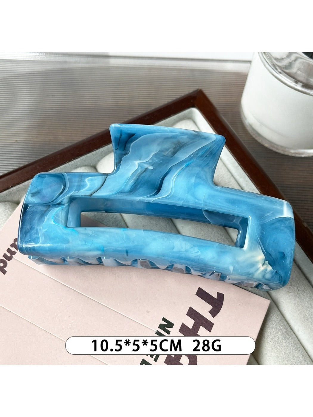 Beau marble pattern square claw clip with a focus on the hinge and clasp