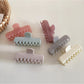 Beau hair clip in pastel blue rectangular design displayed on white surface