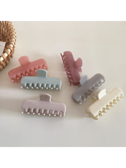 Beau hair clip in pastel blue rectangular design displayed on white surface