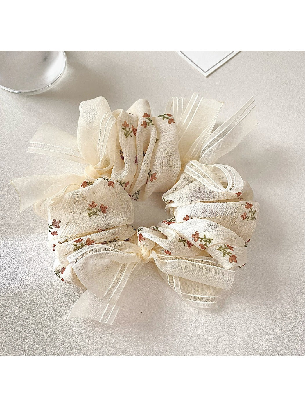 Close-up of Gifty tiny floral print bow scrunchie on white background