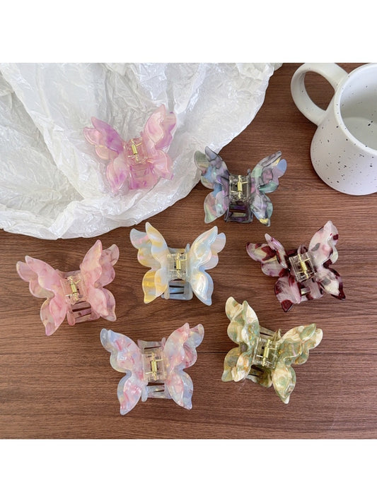 Beau butterfly shaped claw clip in pastel pink on white background