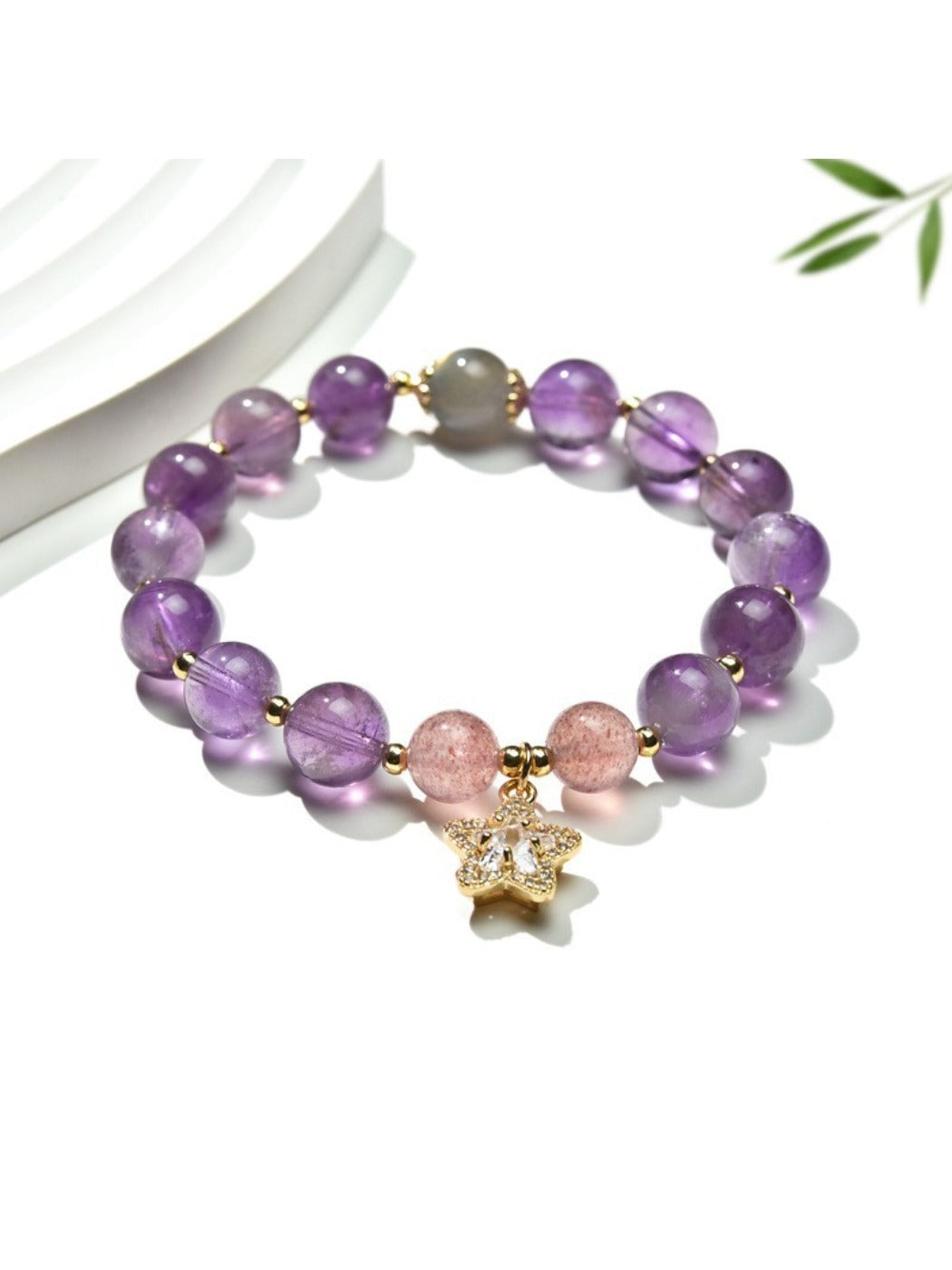 Purple crystal beaded bracelet with silver charm on wrist