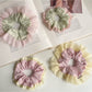Gifty Sweet Color Block Tulle Scrunchie worn on a wrist with soft pastel colors