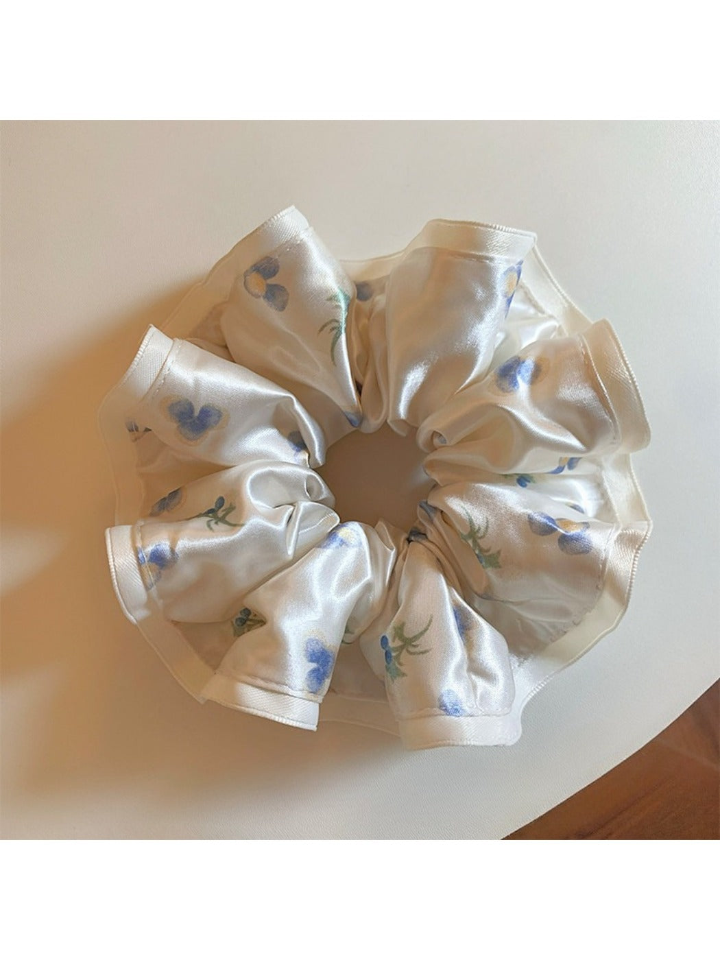 Gifty satin floral print scrunchie styled in long hair against a neutral background