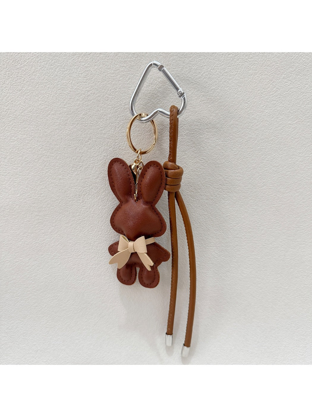 Cartoon bunny keychain displayed on a colorful background