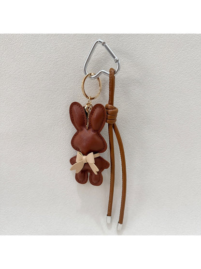 Cartoon bunny keychain displayed on a colorful background