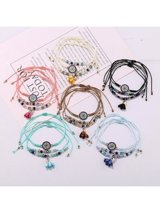 Close-up of Lovra small bead tassel alloy bracelet on a white background