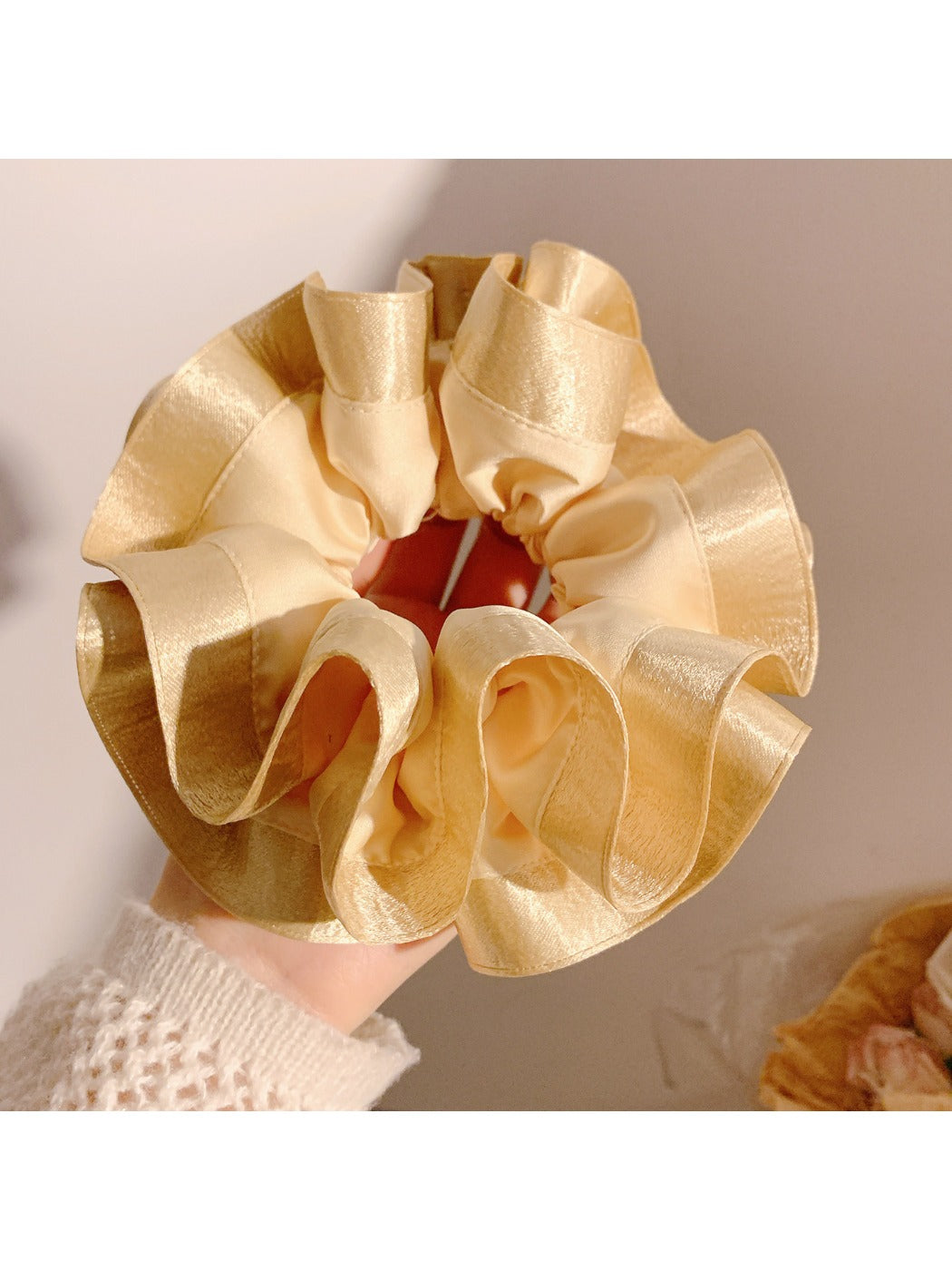 Gifty satin ruffle scrunchie in light blue displayed with matching accessories