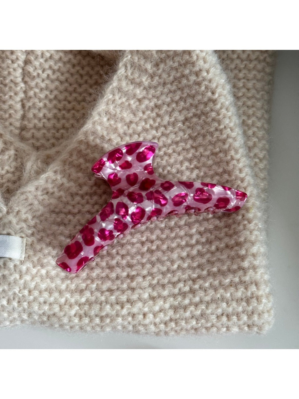 Beau pink leopard print hair clip with light reflecting off acetate material