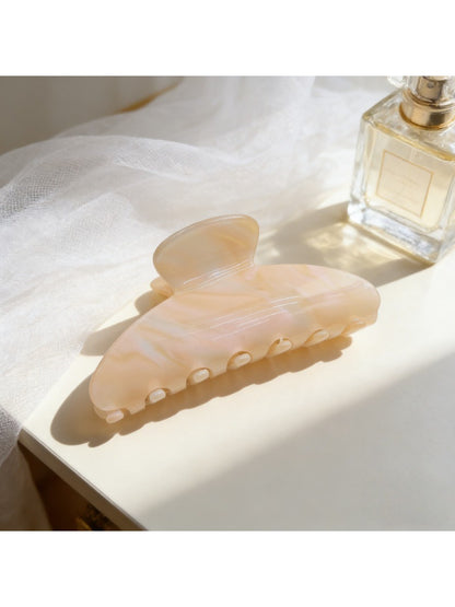 Beau high ponytail claw clip placed next to matching hair accessories on a wooden surface