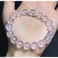 Lovra pink beaded crystal bracelet coiled on white surface showing bead arrangement