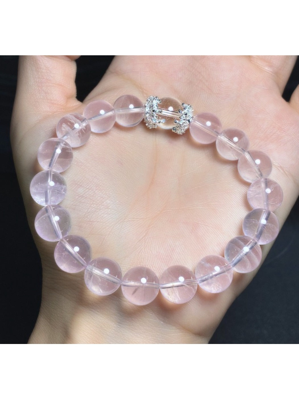 Lovra pink beaded crystal bracelet coiled on white surface showing bead arrangement