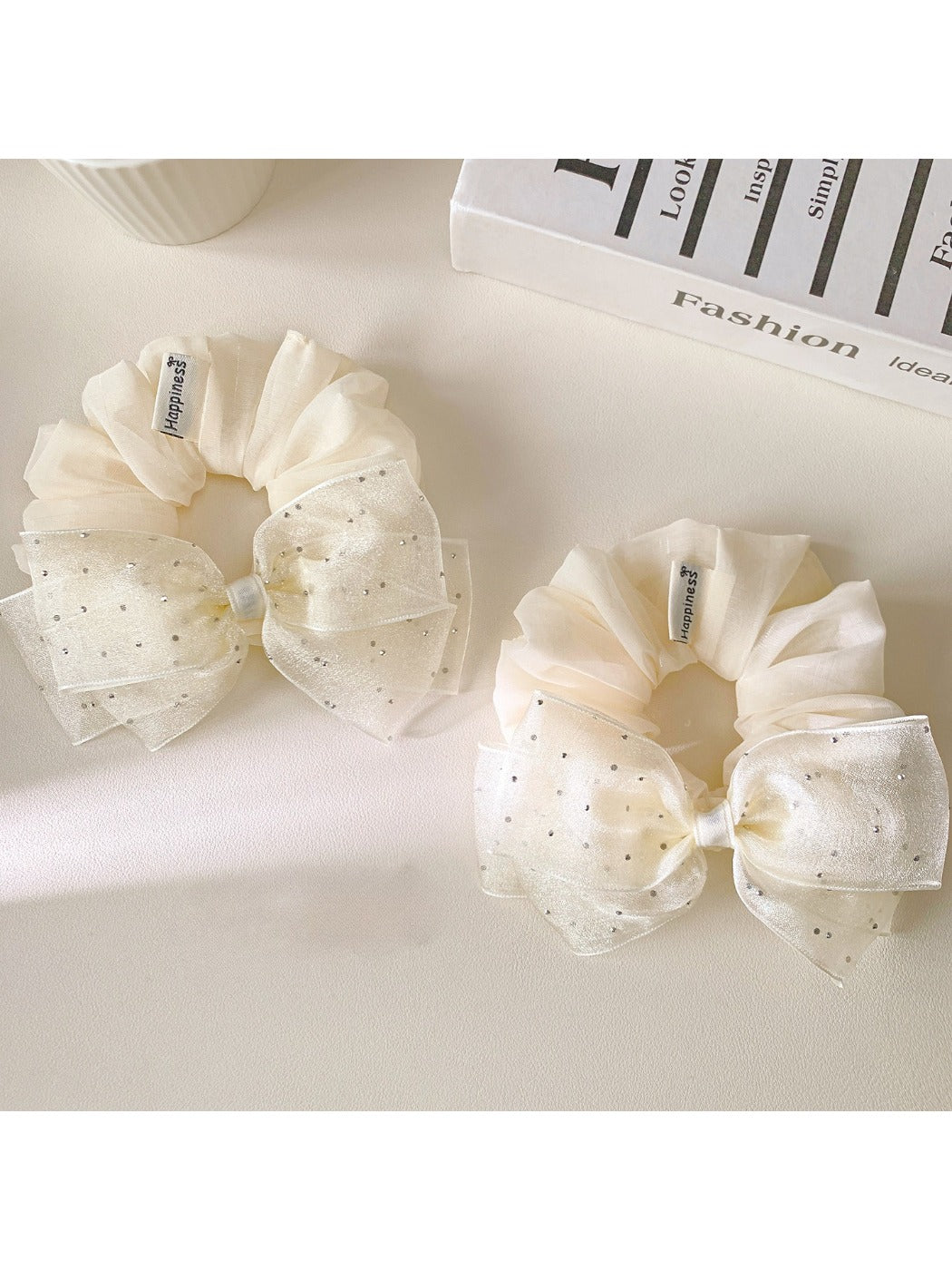 Large pink tulle bow scrunchie on a white background
