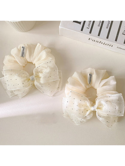 Large pink tulle bow scrunchie on a white background