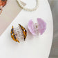 Side view of Beau shell shaped hair claw clip highlighting clasp mechanism