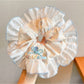 Gifty sweet tiny floral scrunchie laid flat showing gathered fabric and stretch quality