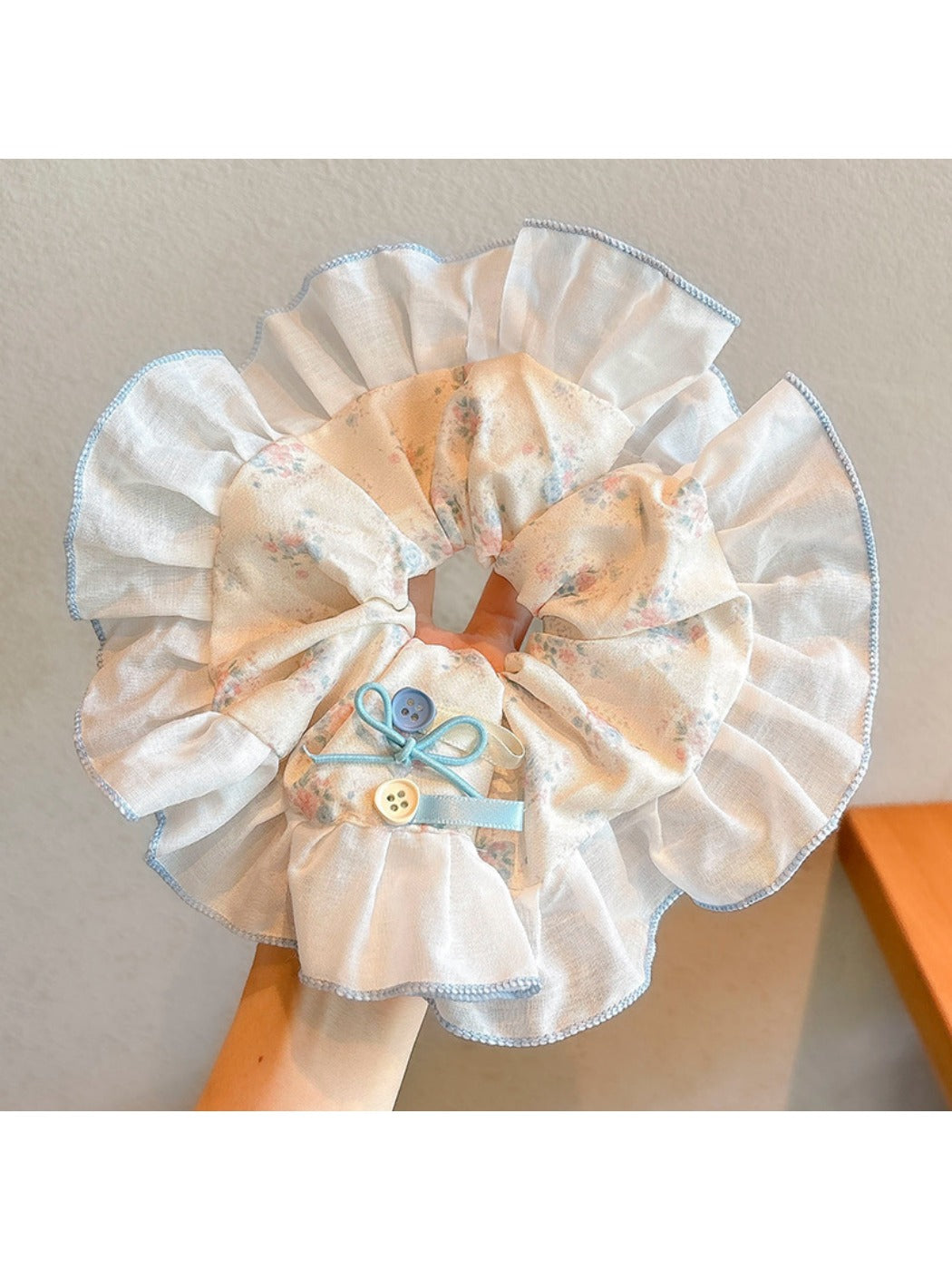 Gifty sweet tiny floral scrunchie laid flat showing gathered fabric and stretch quality