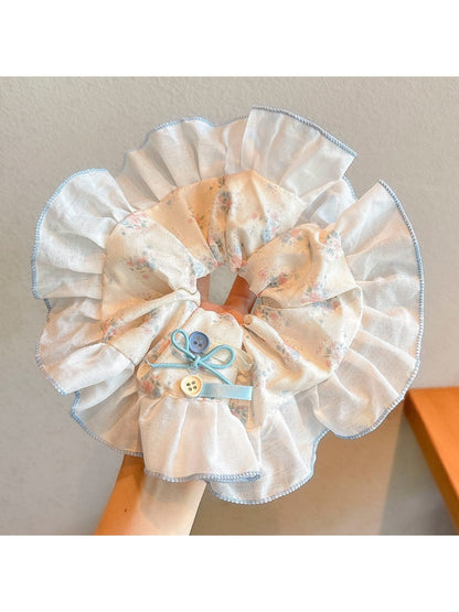 Gifty sweet tiny floral scrunchie laid flat showing gathered fabric and stretch quality