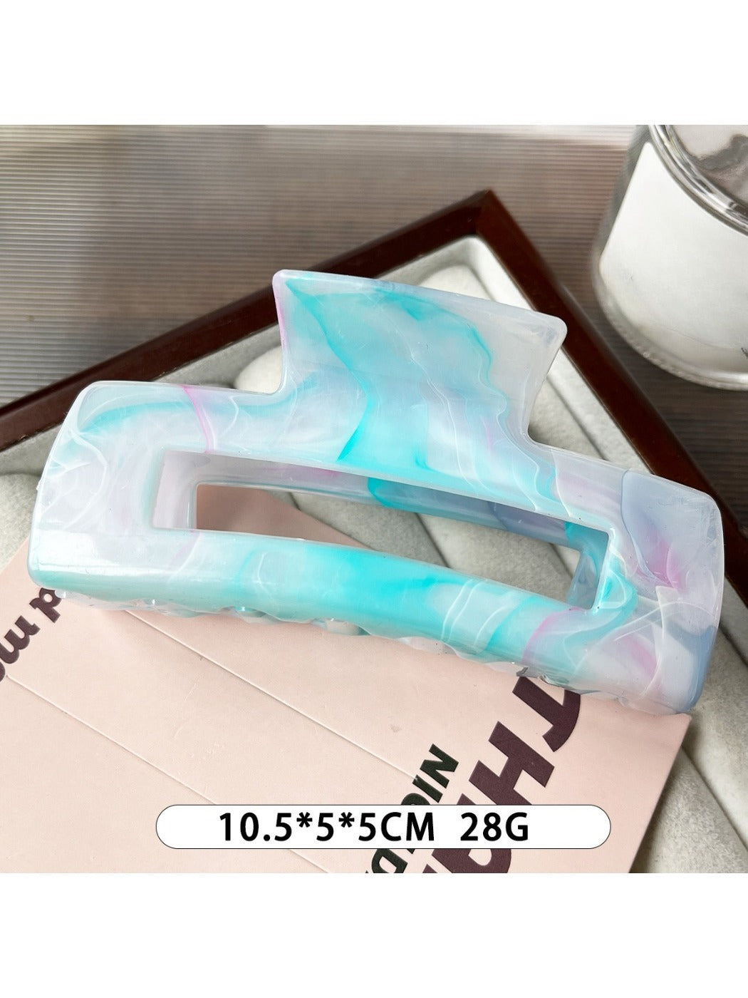 Beau marble pattern square claw clip displayed alongside matching hair accessories