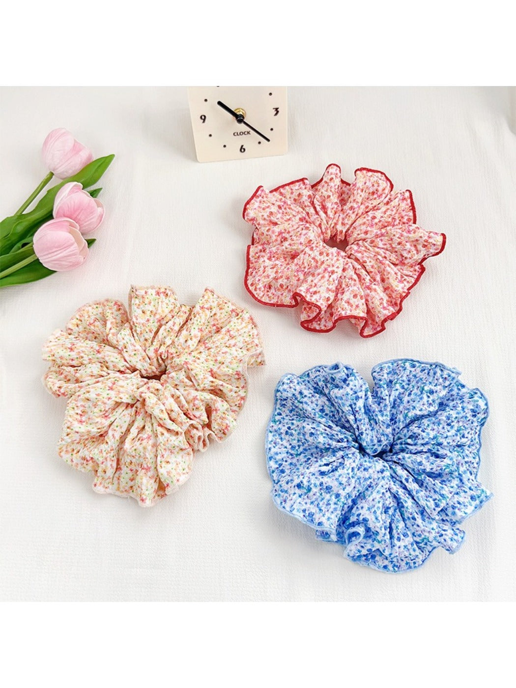 Black and white polka dot scrunchie displayed on a wooden surface