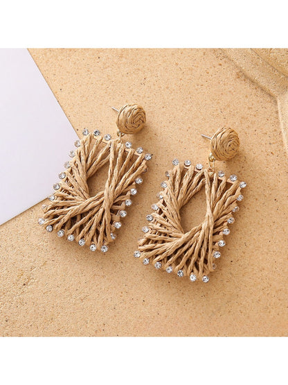 Earedge raffia square drop earrings displayed on a wooden surface