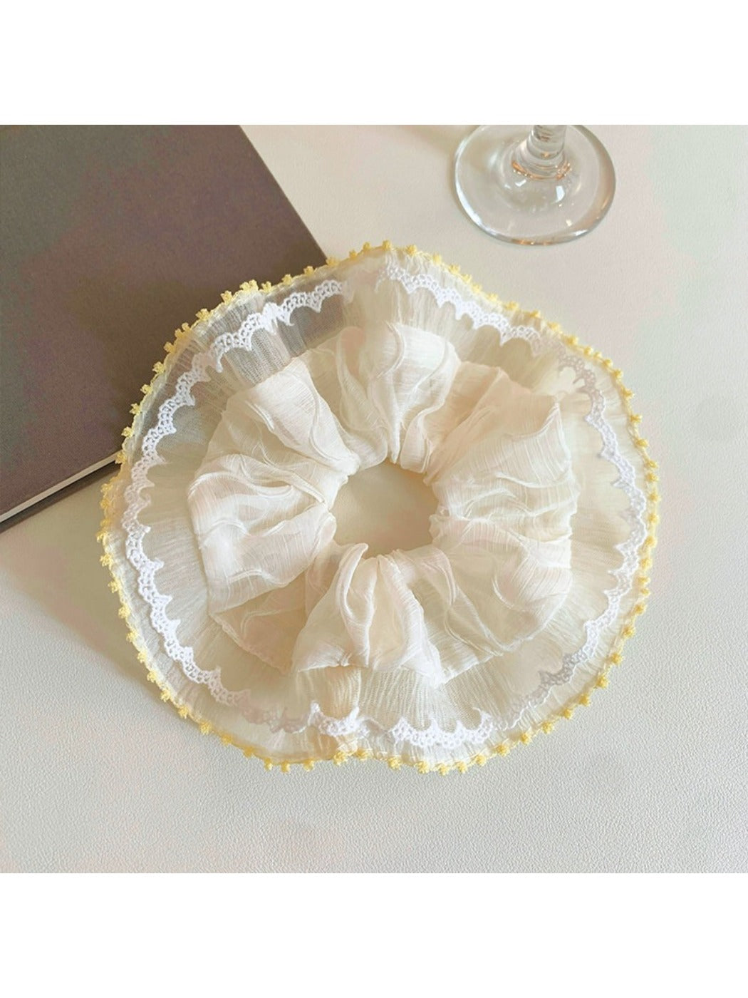 Flat lay of Gifty minimalist ruched scrunchie on a white background