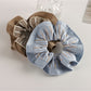 Gifty pastel scrunchie styled on a wrist as a fashion accessory