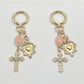 Close-up of the vintage cross pendant showing detailed engravings