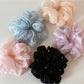 Close-up of Gifty Comfy Foggy Simplicity scrunchie in soft pastel fabric
