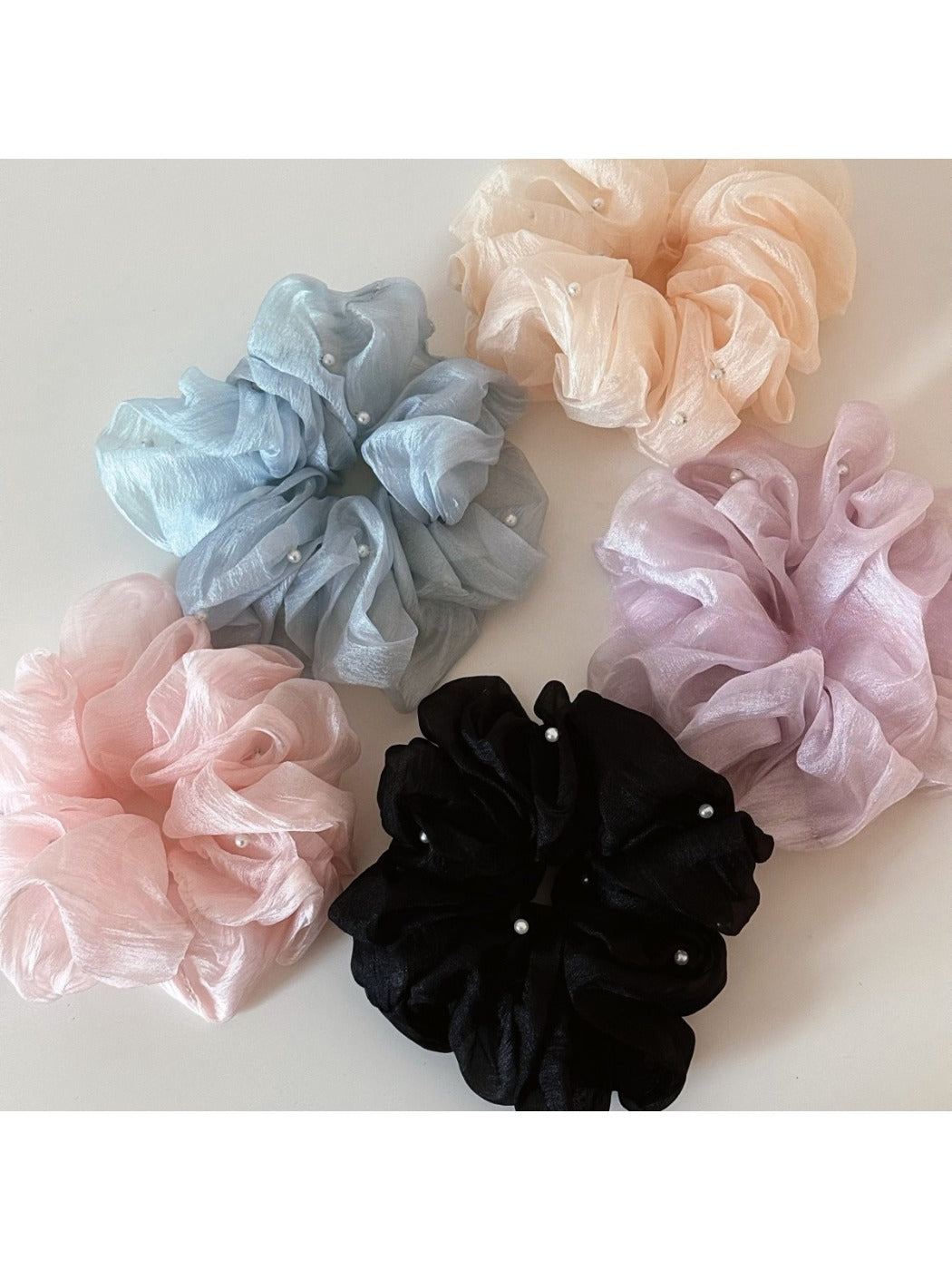 Close-up of Gifty Comfy Foggy Simplicity scrunchie in soft pastel fabric