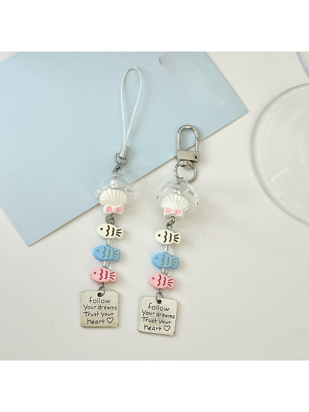 Close-up of a single pastel blue fish-shaped keychain with textured details