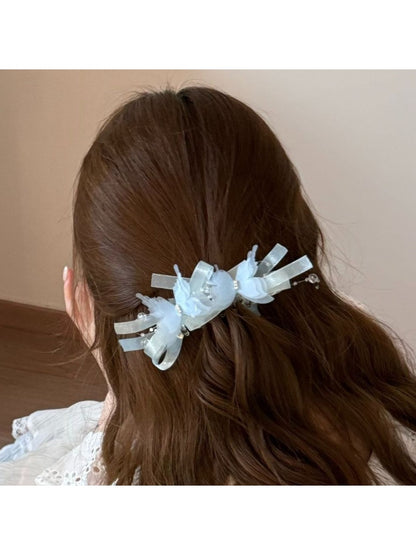 Beau banana clip displayed open to show the clasp mechanism and butterfly embellishments