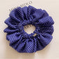 Classic polka dot ruffled scrunchie in black and white fabric close-up