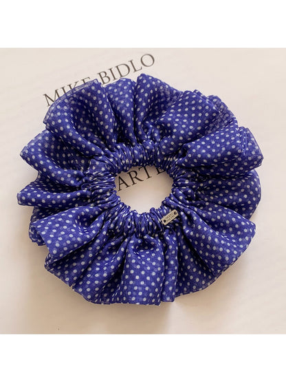 Classic polka dot ruffled scrunchie in black and white fabric close-up