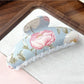 Beau hair clip styled in hair, showcasing vibrant flower pattern and secure hold