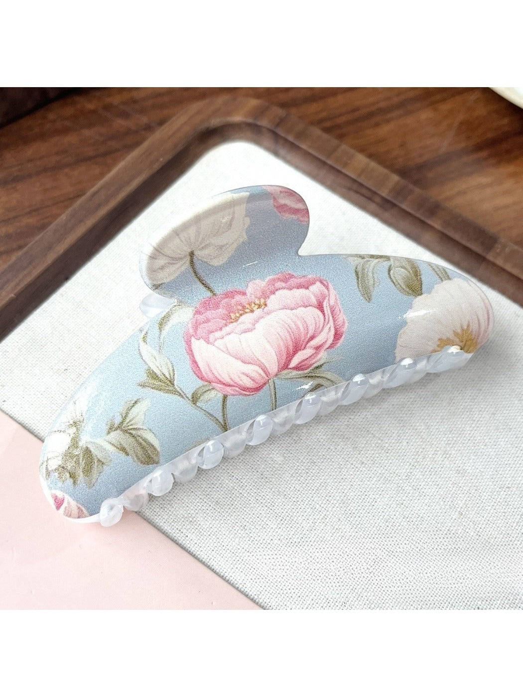 Beau hair clip styled in hair, showcasing vibrant flower pattern and secure hold