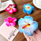 Beau hibiscus claw clip held in hand to show size and shape